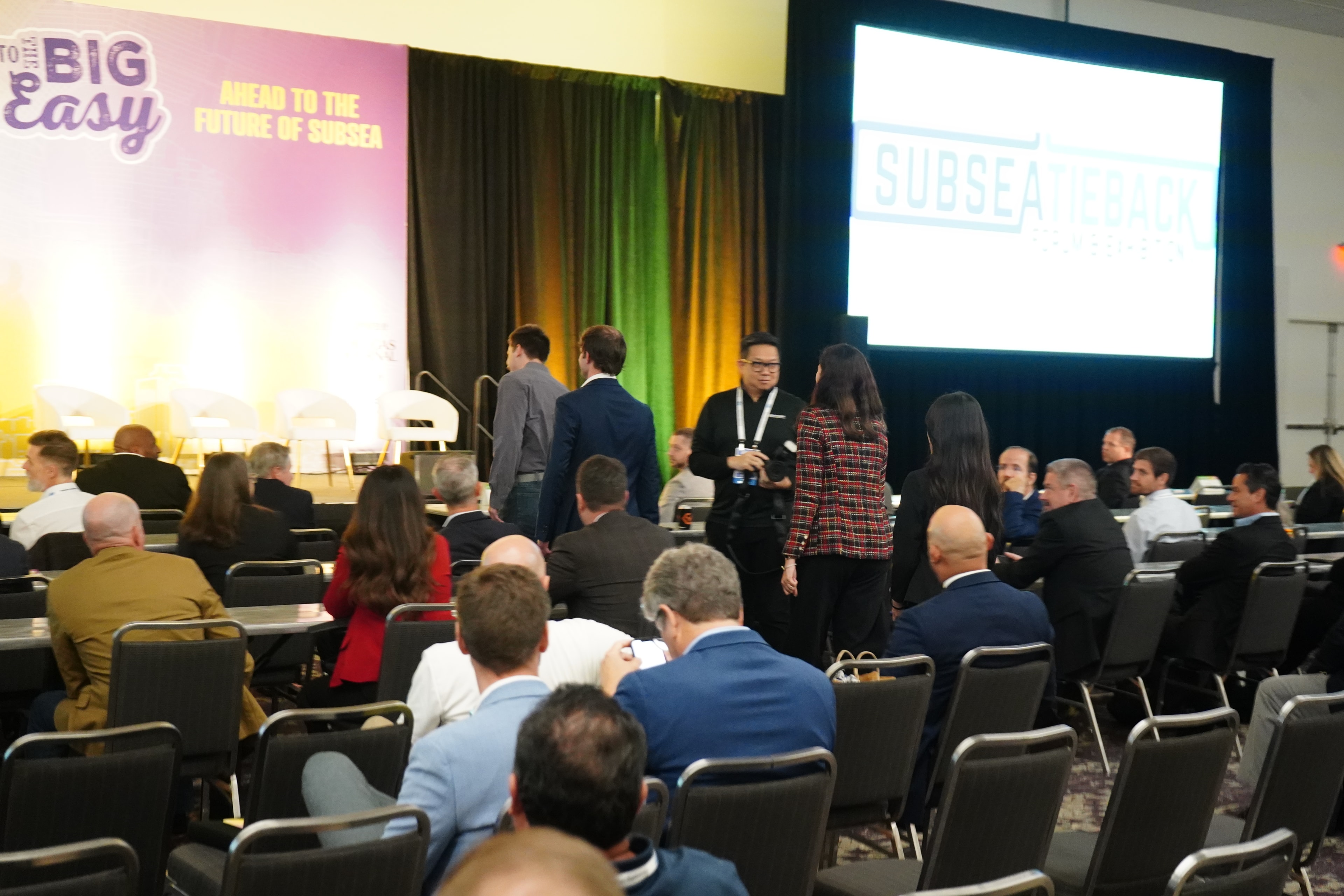 Conference attendees and presenters on stage at the Subsea Tieback Forum