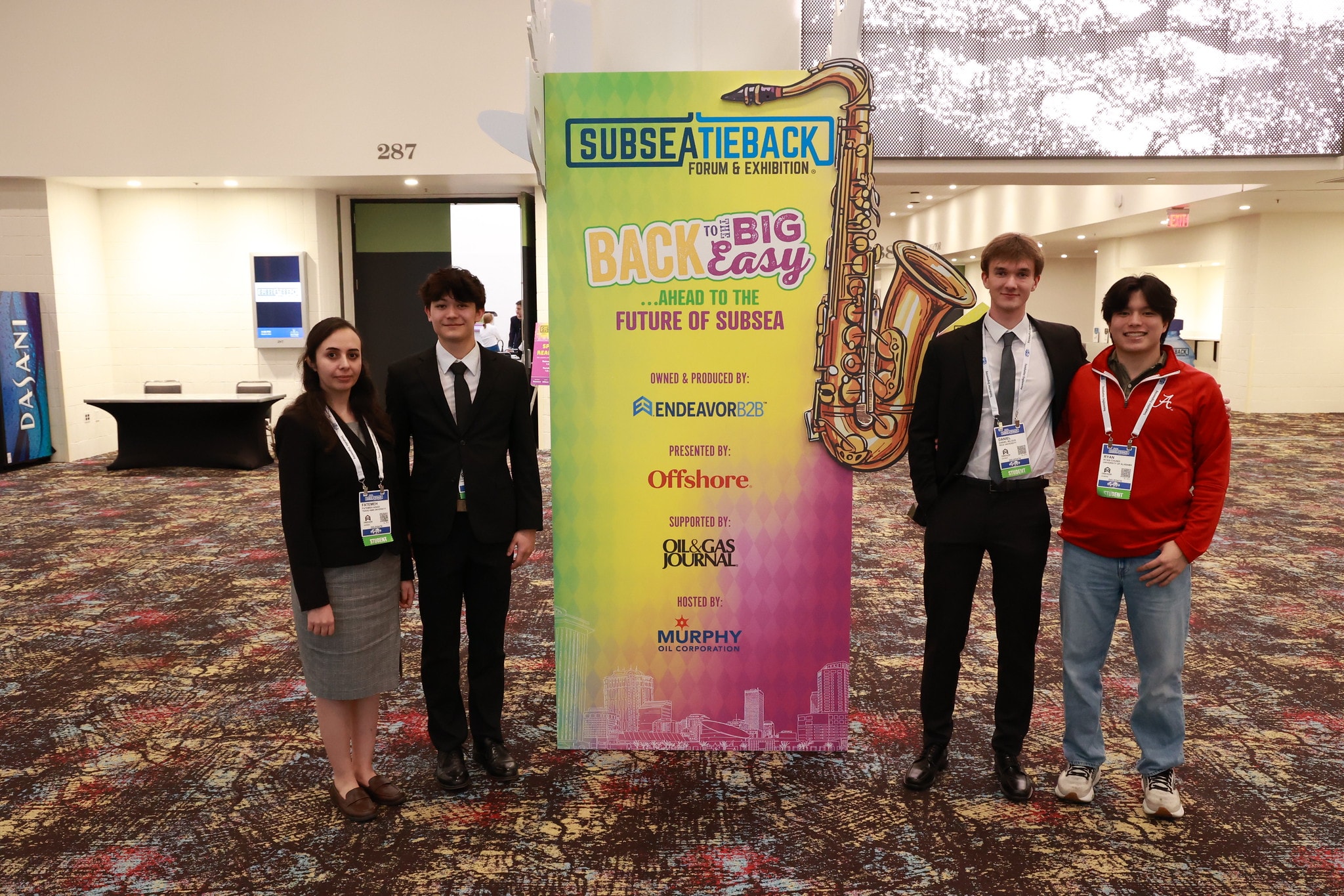 Student team posing by the Subsea Tieback Forum banner