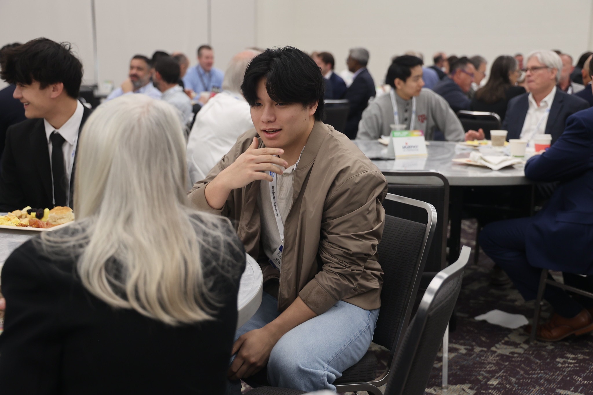 Student networking with industry professionals at the forum
