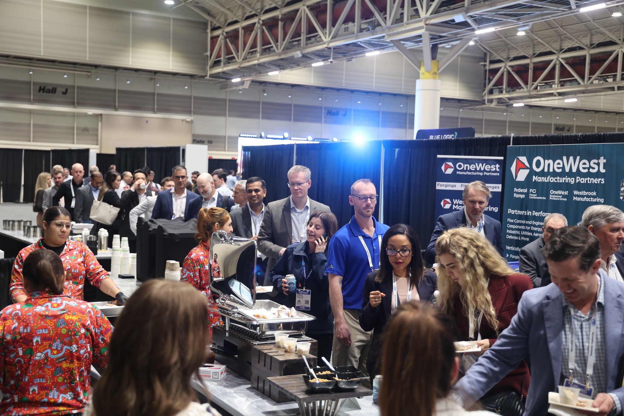 Attendees networking at the exhibition hall food station